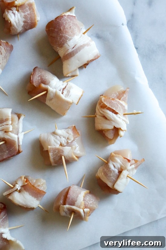 Bacon wrapped chicken bites are the easiest appetizer, made with just TWO ingredients. Using the air fryer, the bacon comes out crisp on the outside, and the chicken juicy and tender inside.