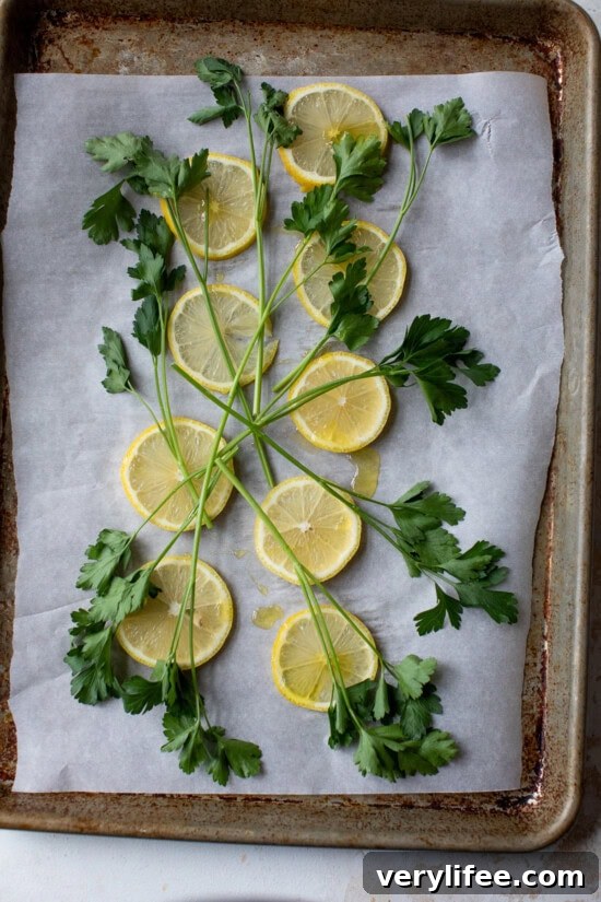 Lemon Garlic Oven-Baked Salmon Recipe 6 lemons and parsley on a sheet pan