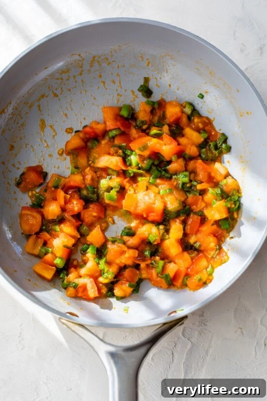 Tomatoes and scallions cooked in skillet
