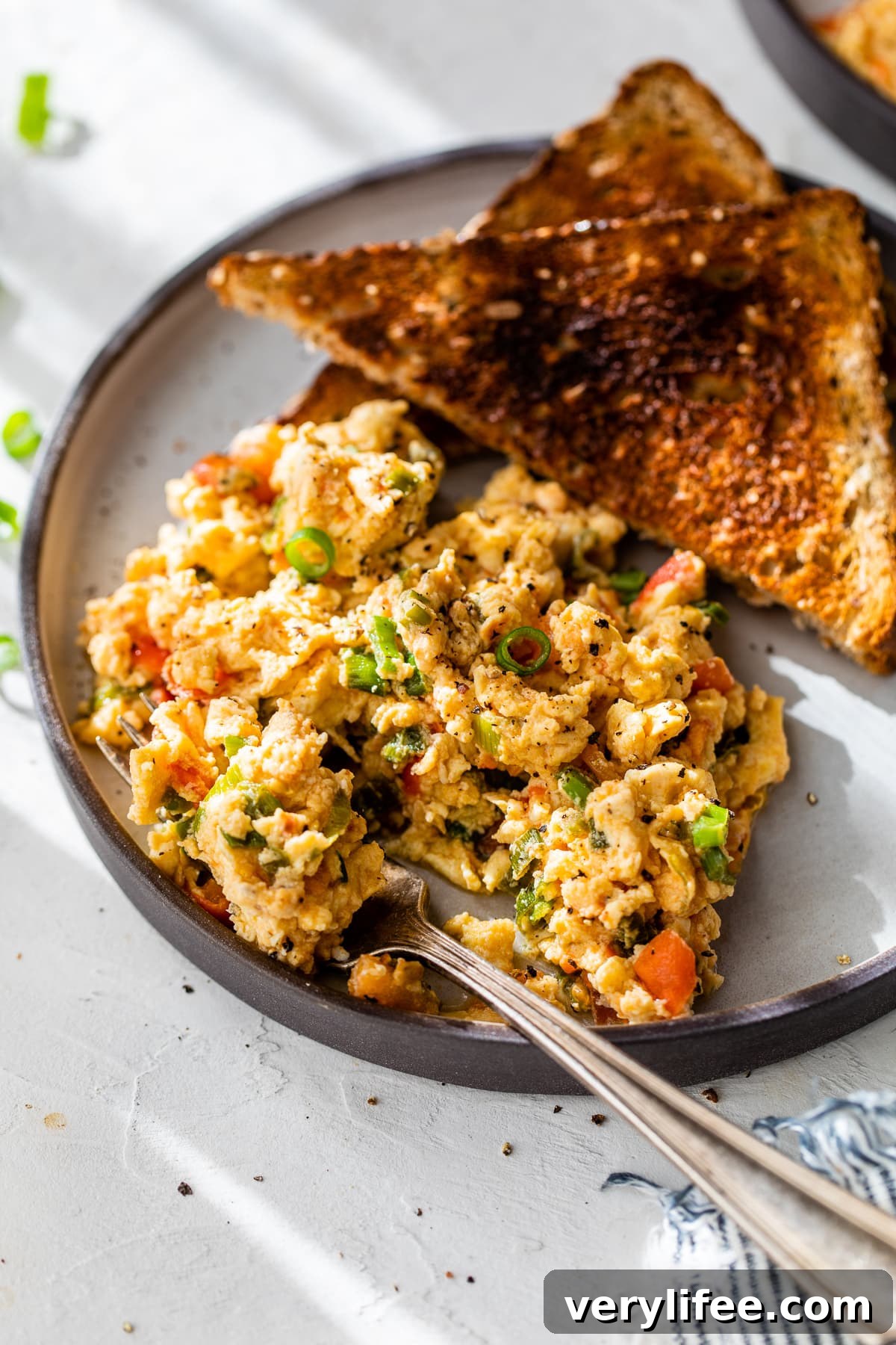 Huevos pericos on plate with fork and toast
