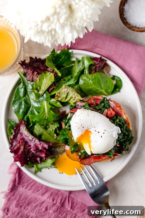 Poached egg over Canadian bacon and chard on an English muffin