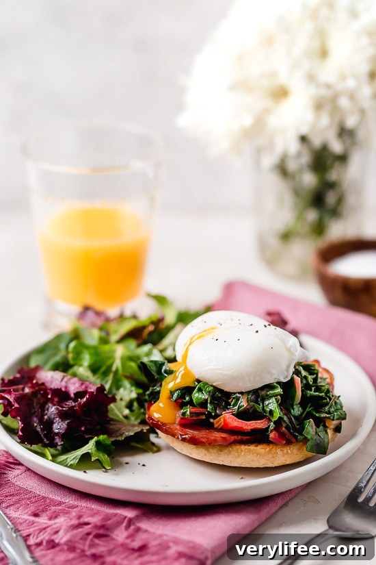 Sliced Swiss chard and prepared Eggs Benedict plated