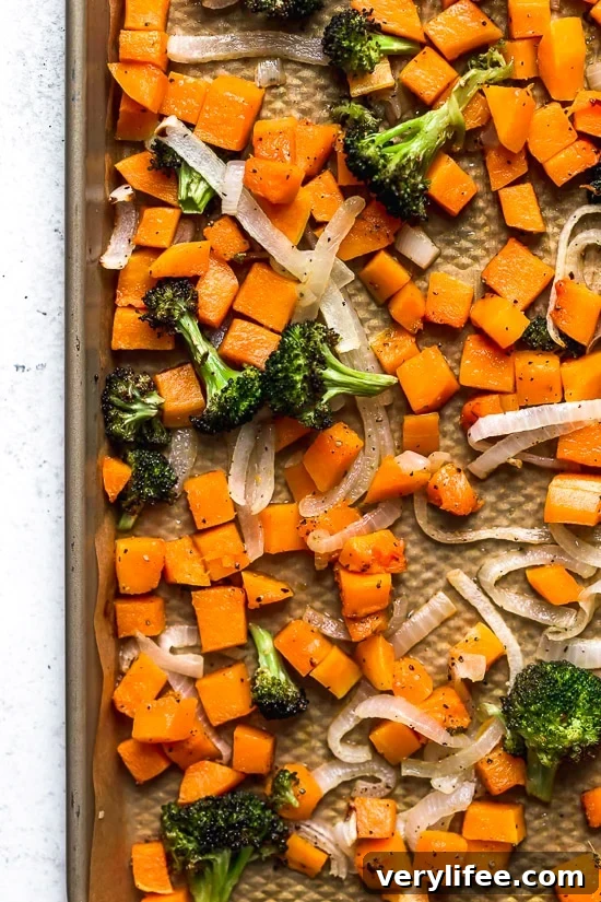 Roasted broccoli, butternut squash and onions Overhead view of roasted broccoli, butternut squash, and onions on pan