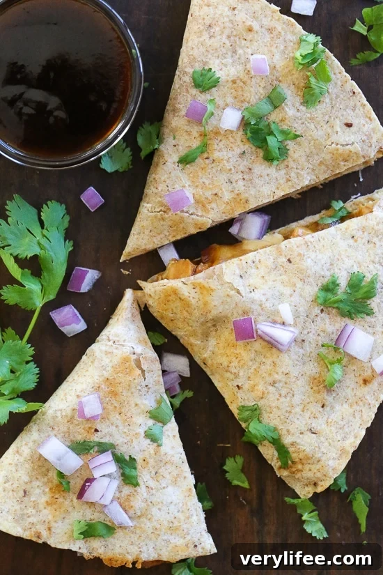 Smoky BBQ Chicken Quesadilla with Gooey Cheddar 4 Folded and crispy BBQ Chicken Quesadilla.