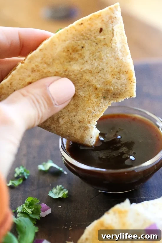 Smoky BBQ Chicken Quesadilla with Gooey Cheddar 5 Sliced BBQ Chicken Quesadilla with filling visible.