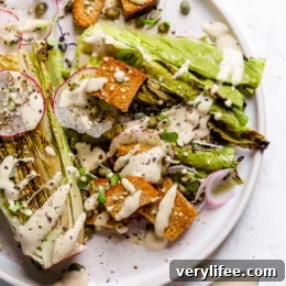 Vegan Caesar salad on plate with creamy dressing.