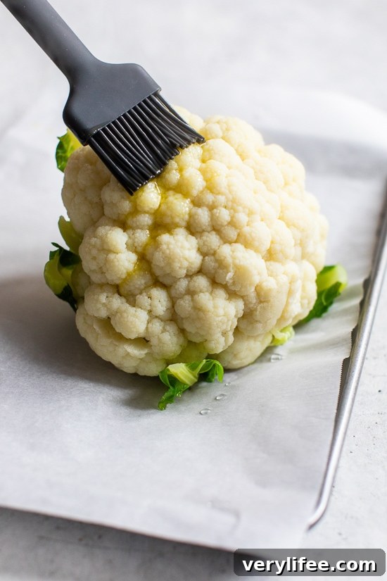 Whole Roasted Baby Cauliflower with Garlic and Herbs 6 Brushing cauliflower with olive oil