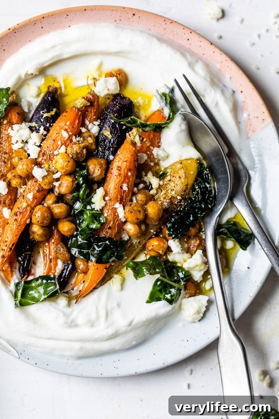 Roasted Carrots and Chickpeas seasoned with za’atar and served over Greek yogurt with lemony kale makes a wonderful side dish or meatless main!