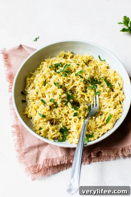 Rice pilaf in bowl with parsley for garnish.