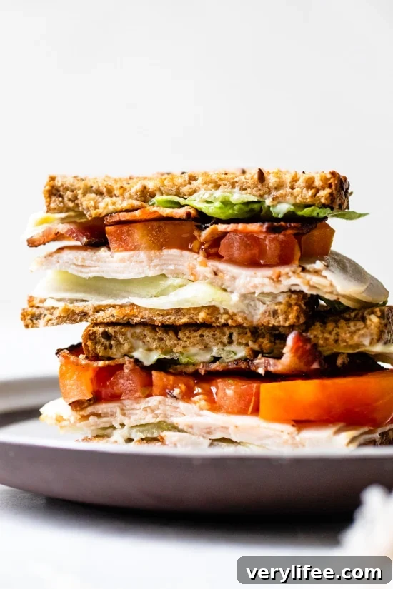 Classic Turkey Club Sandwich Recipe with Bacon and Avocado 2 A classic Turkey Club sandwich made healthy, piled high with turkey breast, bacon, lettuce, and tomato on whole grain bread, the perfect easy lunch.