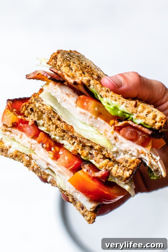 Classic Turkey Club Sandwich Recipe with Bacon and Avocado 3 A classic Turkey Club sandwich made healthy, piled high with turkey breast, bacon, lettuce, and tomato on whole grain bread, the perfect easy lunch.