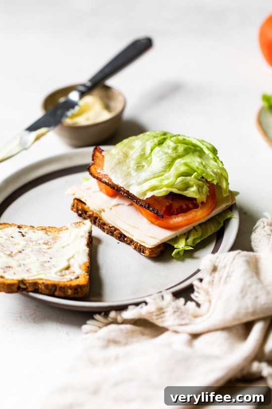 Classic Turkey Club Sandwich Recipe with Bacon and Avocado 6 A classic Turkey Club sandwich made healthy, piled high with turkey breast, bacon, lettuce, and tomato on whole grain bread, the perfect easy lunch.