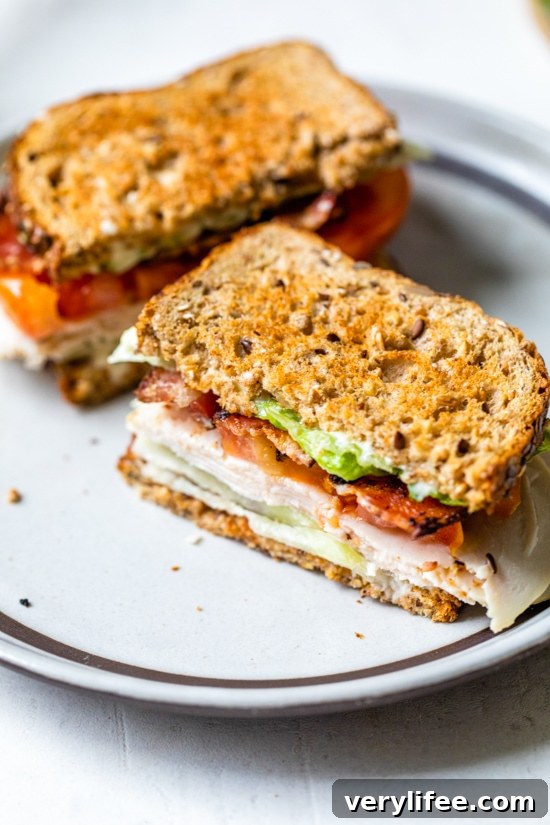 Classic Turkey Club Sandwich Recipe with Bacon and Avocado 7 A classic Turkey Club sandwich made healthy, piled high with turkey breast, bacon, lettuce, and tomato on whole grain bread, the perfect easy lunch.