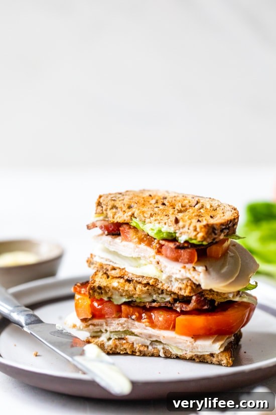 Classic Turkey Club Sandwich Recipe with Bacon and Avocado 8 A classic Turkey Club sandwich made healthy, piled high with turkey breast, bacon, lettuce, and tomato on whole grain bread, the perfect easy lunch.