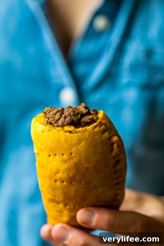 Girl holding a Jamaican Beef Patty