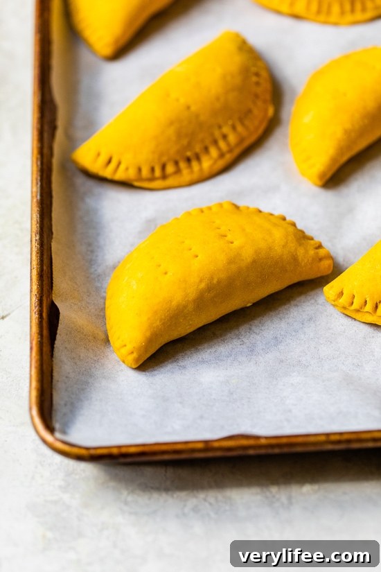 beef patties on a baking sheet
