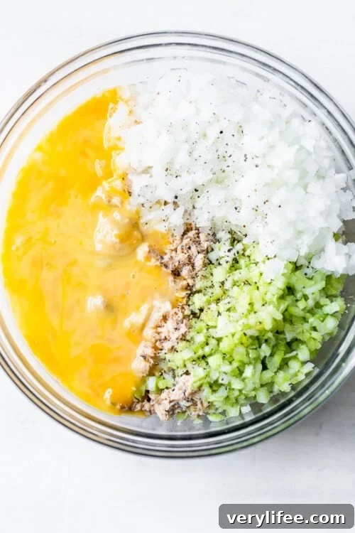 salmon, onion, celery and egg in a bowl