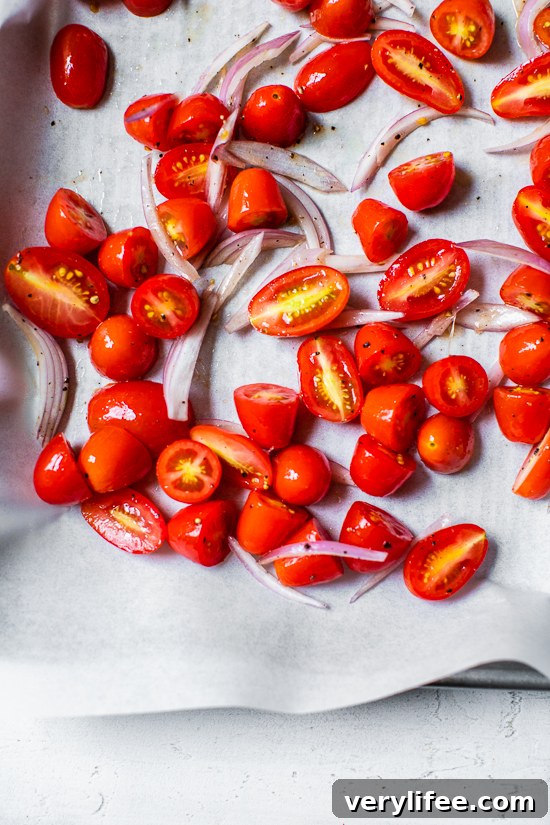 Creamy Whipped Ricotta Toast with Roasted Tomatoes 4 tomatoes on sheet pan with parchment