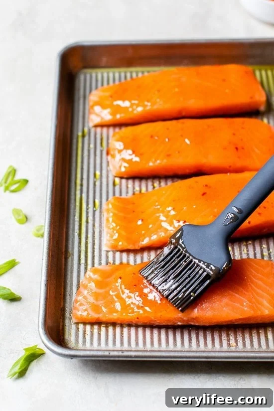 Honey-Chili Glazed Salmon Recipe: Sweet and Spicy 3 brushing glaze on salmon