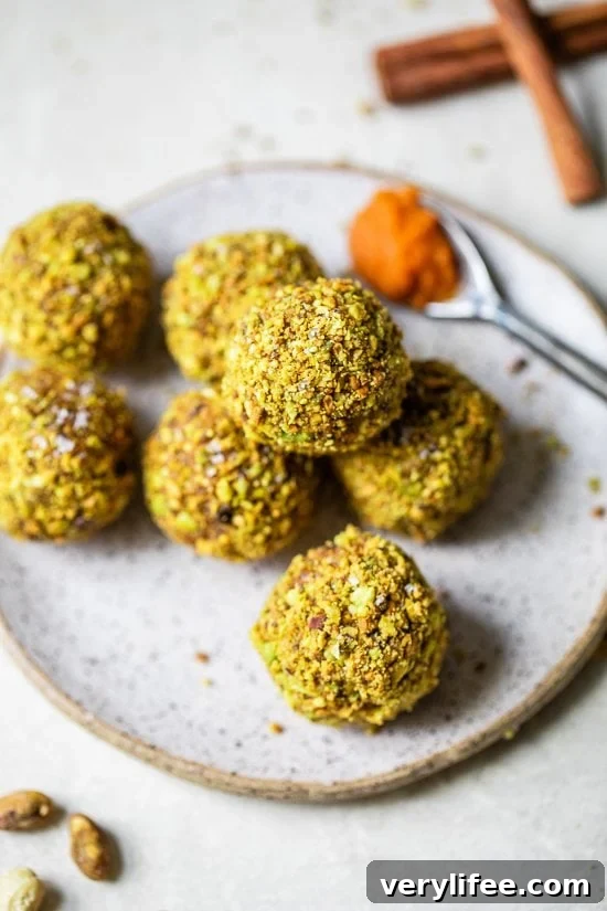 Made with cashews, pistachios, dates, pumpkin and spices, these no-bake Pumpkin Pistachio Energy Balls taste like little bites of pumpkin pie. Pumpkin Pistachio Energy Balls piled on a plate