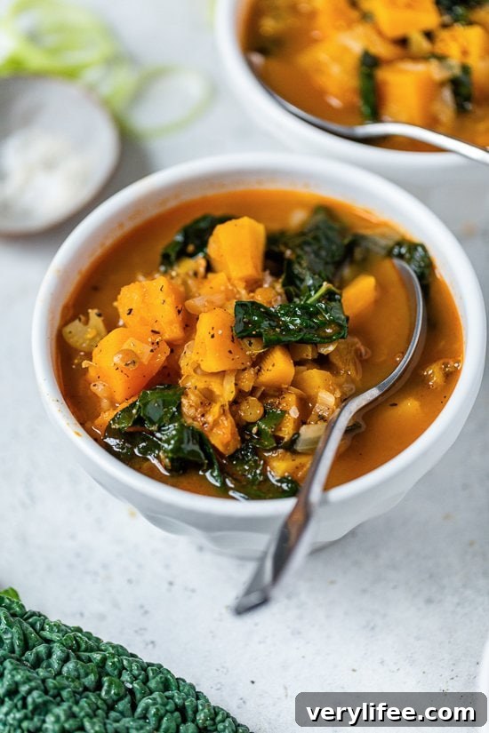 Creamy Roasted Butternut Squash and Lentil Soup 4 Lentil Soup with Butternut and Kale with a spoon