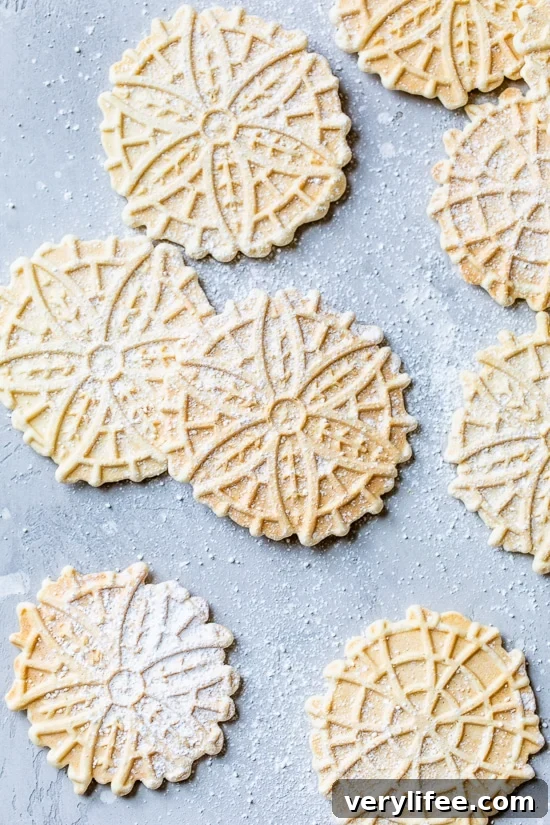 Authentic Italian Pizzelle Cookie Recipe 2 Pizzelle Cookies with powdered sugar