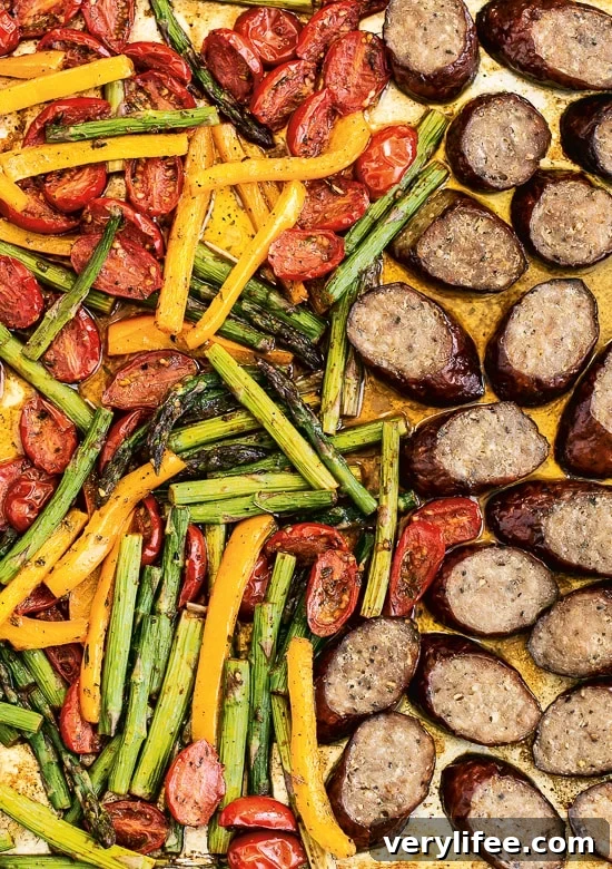Sheet pan dinner with kielbasa, asparagus, tomatoes and peppers