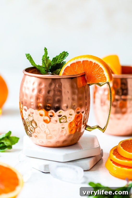 orange moscow mule in copper mugs