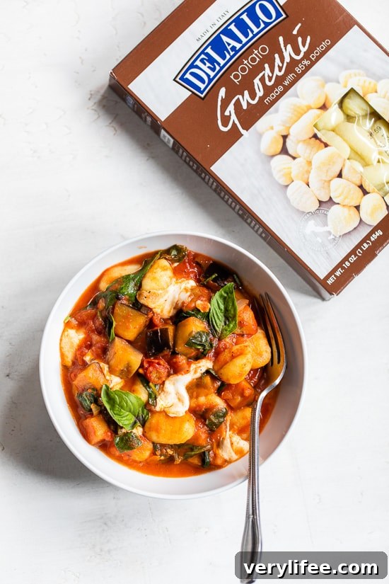 Eggplant with gnocchi sauce and mozzarella in a bowl.