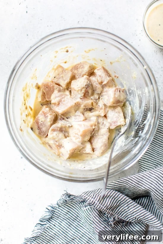 chicken breast marinating in Caesar dressing