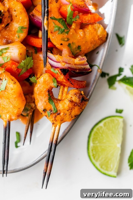 Shrimp Skewers with onions, bell pepper and lime wedges