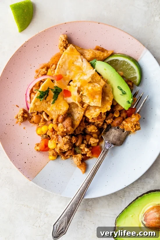 Dish with turkey taco meat, chips, avocado.