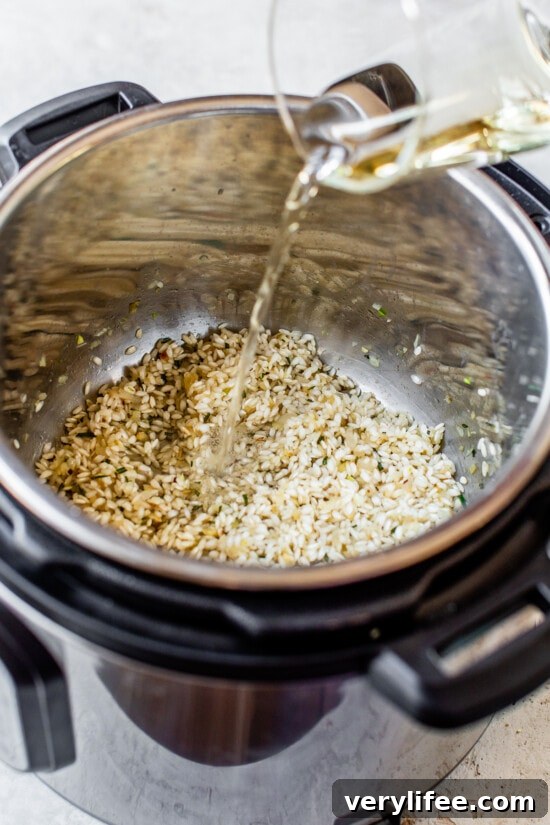 Broth being added to an Instant Pot with risotto