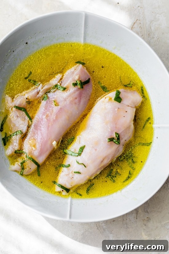 Chicken marinating in the citrus dressing for a summer chicken salad.
