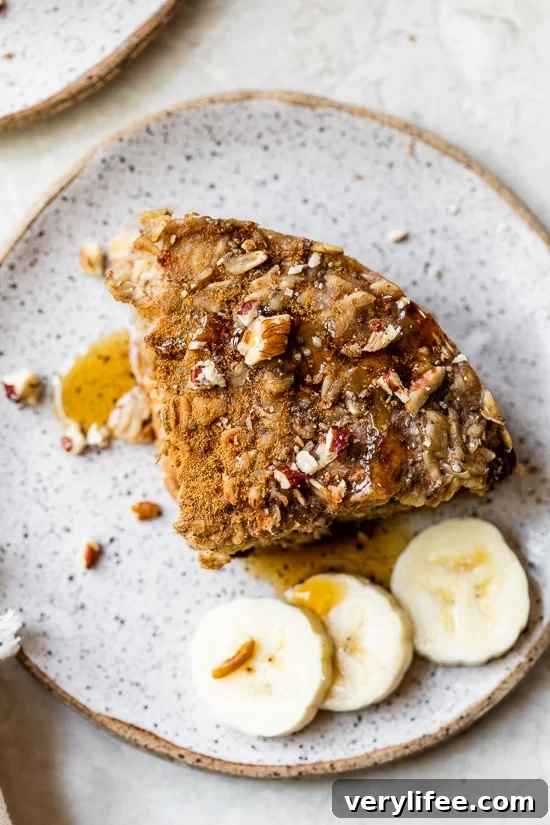 A baked oatmeal bar on a plate with banana slices