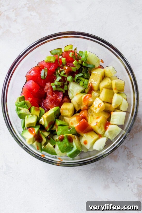 How to Make Tuna Tartare with Avocado, Soy and Citrus 4 tuna, scallions, cucumber, avocado in a bowl