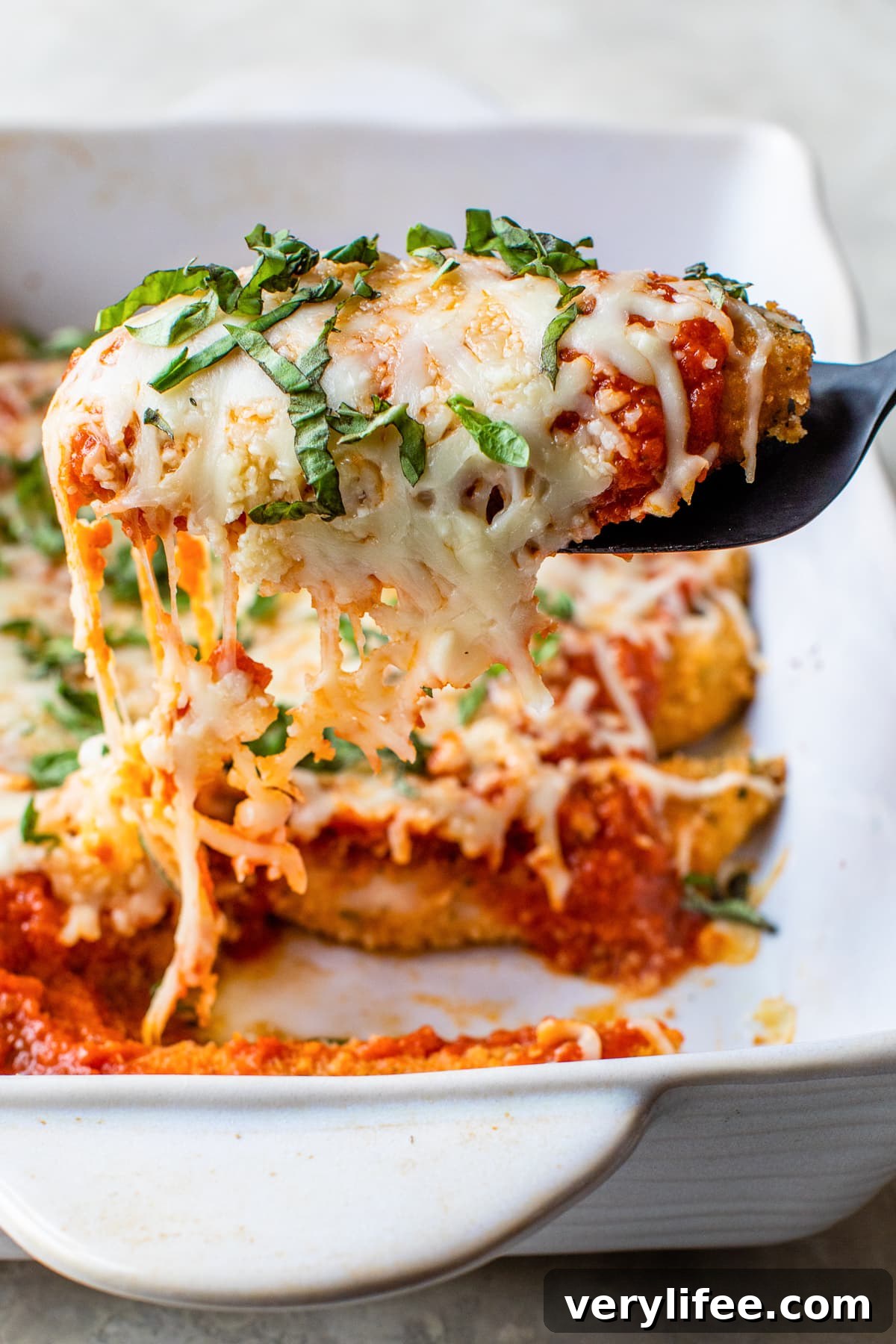 Chicken Tenders Parmesan on a spatula Chicken Tenders Parmesan on a spatula