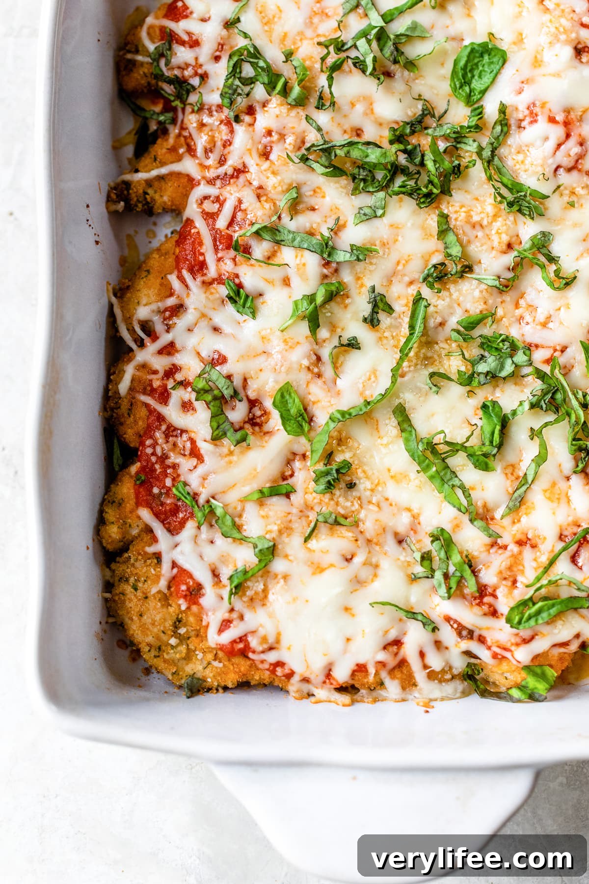 Chicken Tenders Parmesan in a baking dish Baked Chicken tenderloin Parmesan in a baking dish