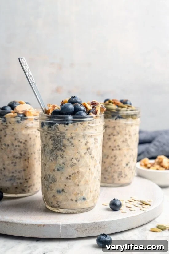 3 jars of overnight oats topped with blueberries and walnuts
