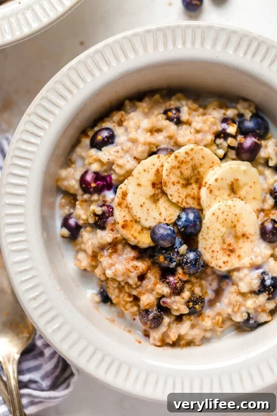 A bowl of steel cut oats topped with blueberries and bananas.