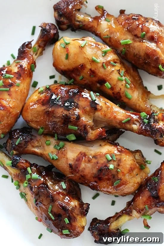 These sweet 'n spicy Asian glazed grilled drumsticks are finger licking good! An inexpensive, weeknight dish you'll want to make all summer long!