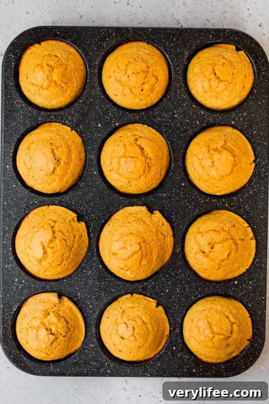 Pumpkin Cornbread Muffins in muffin tin